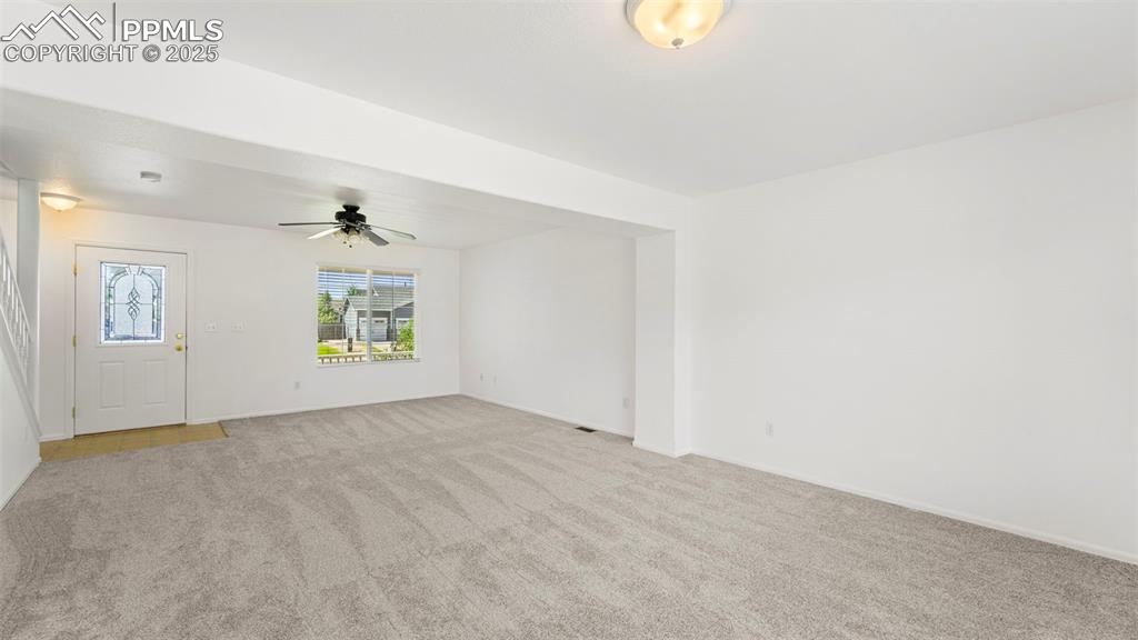 Image 6 of 46: Unfurnished room featuring light carpet and a ceiling fan