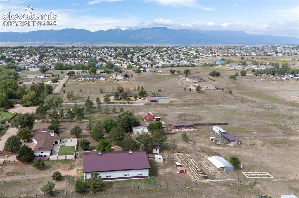 Image 44 of 50: Expansive property featuring multiple outbuildings, fenced enclosures, and