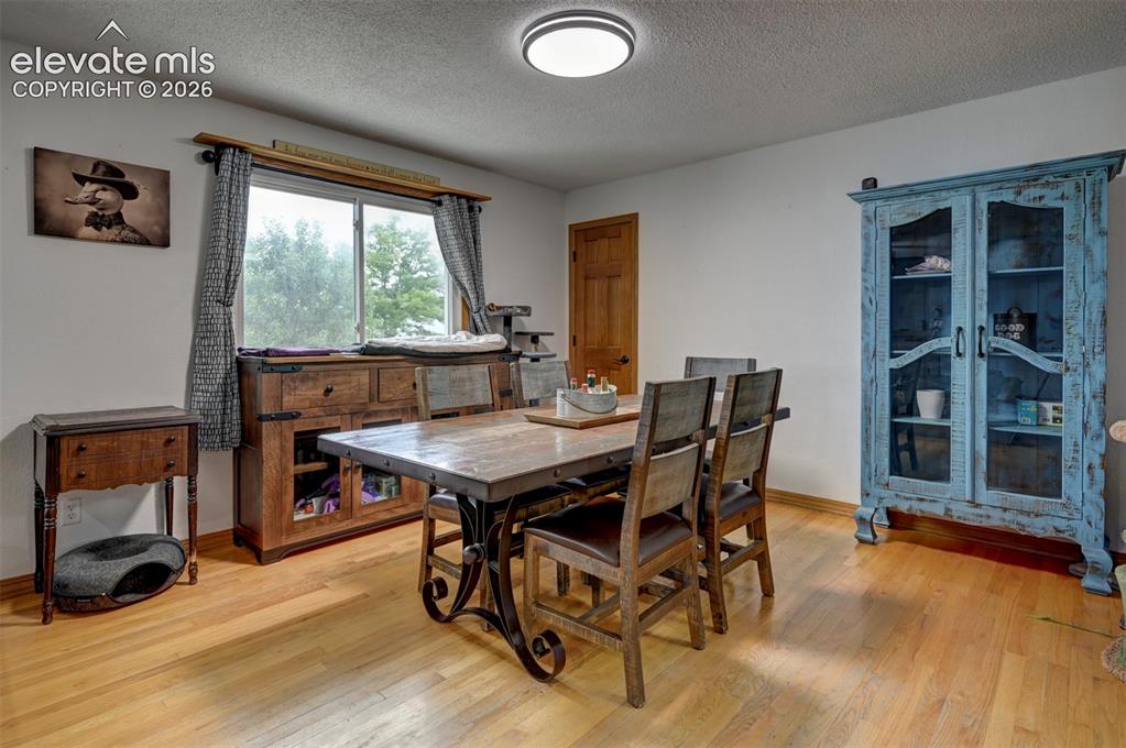 Image 8 of 50: Hardwood flooring, white walls, flush mount ceiling light, and a natural wo
