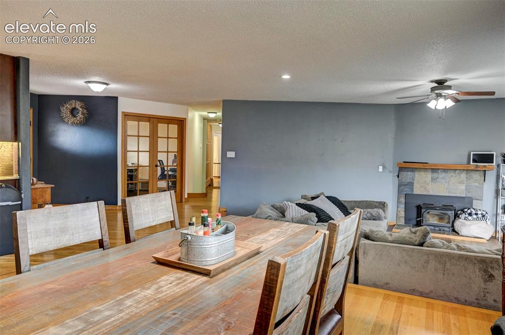 Image 9 of 50: Hardwood flooring throughout, recessed lighting, and a slate-tiled fireplac