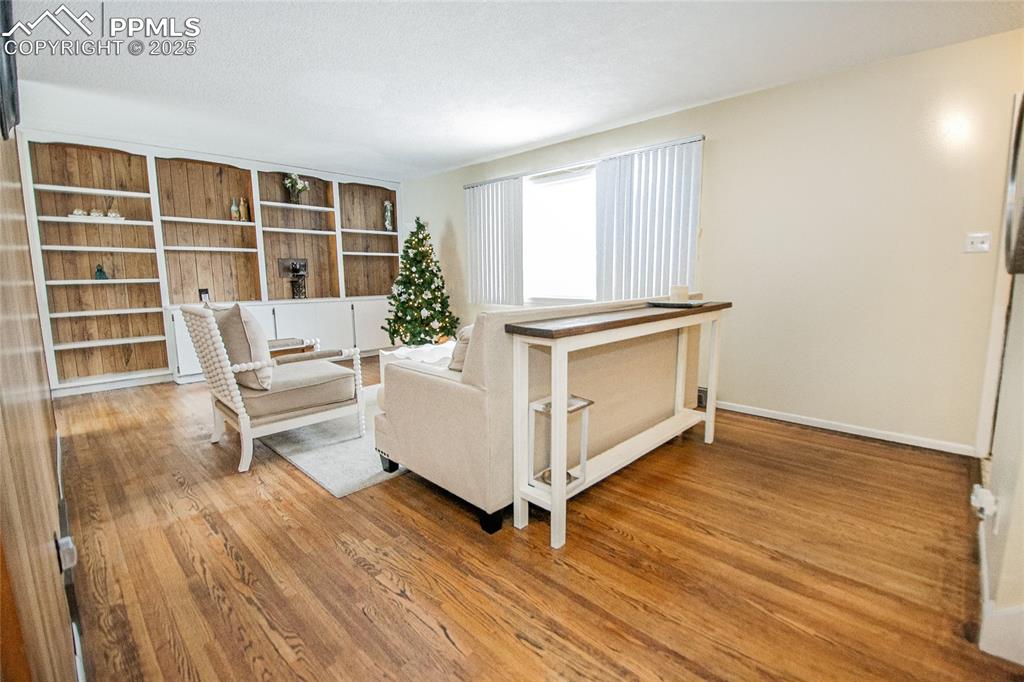 Image 20 of 48: Unfurnished room with hardwood / wood-style flooring and a textured ceiling