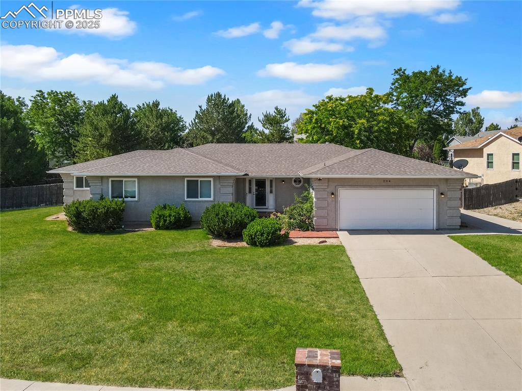 Image 1 of 27: Ranch-style home with a shingled roof, an attached garage, driveway, and st