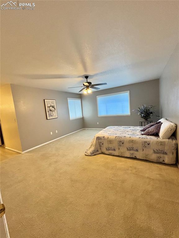 Image 16 of 27: Bedroom featuring light carpet and ceiling fan