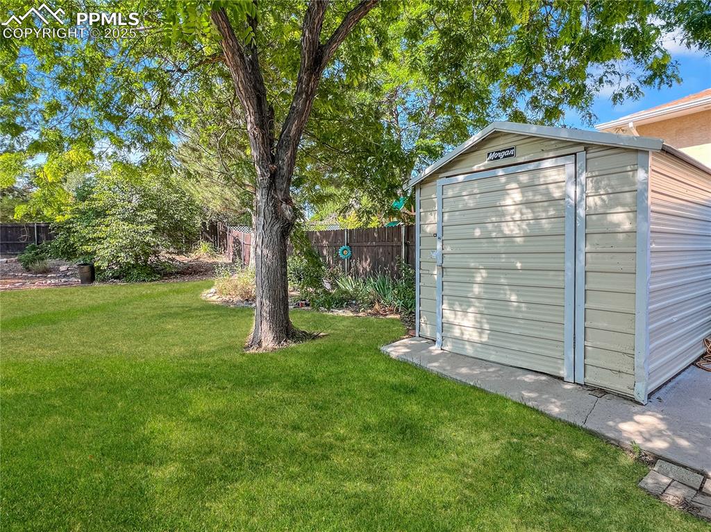 Image 7 of 25: View of yard with a storage shed