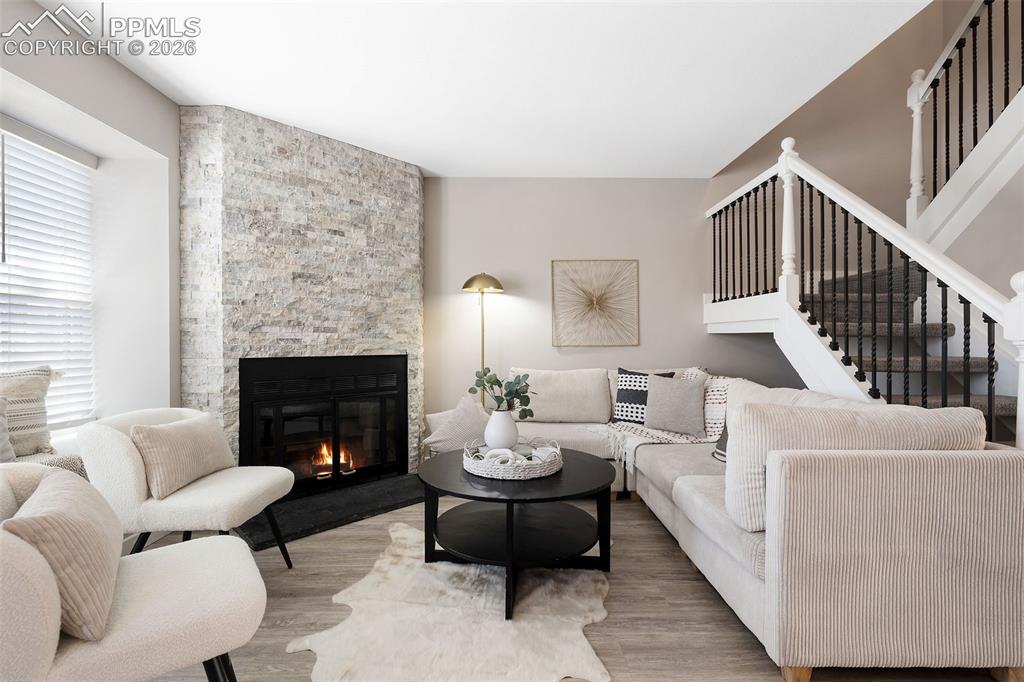 Caption: Living area featuring a floor-to-ceiling stone fireplace