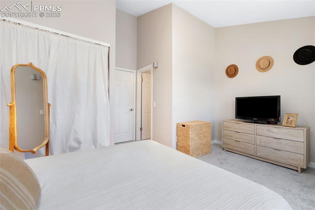 Image 15 of 26: Spacious room featuring light-toned carpeting and neutral wall tones