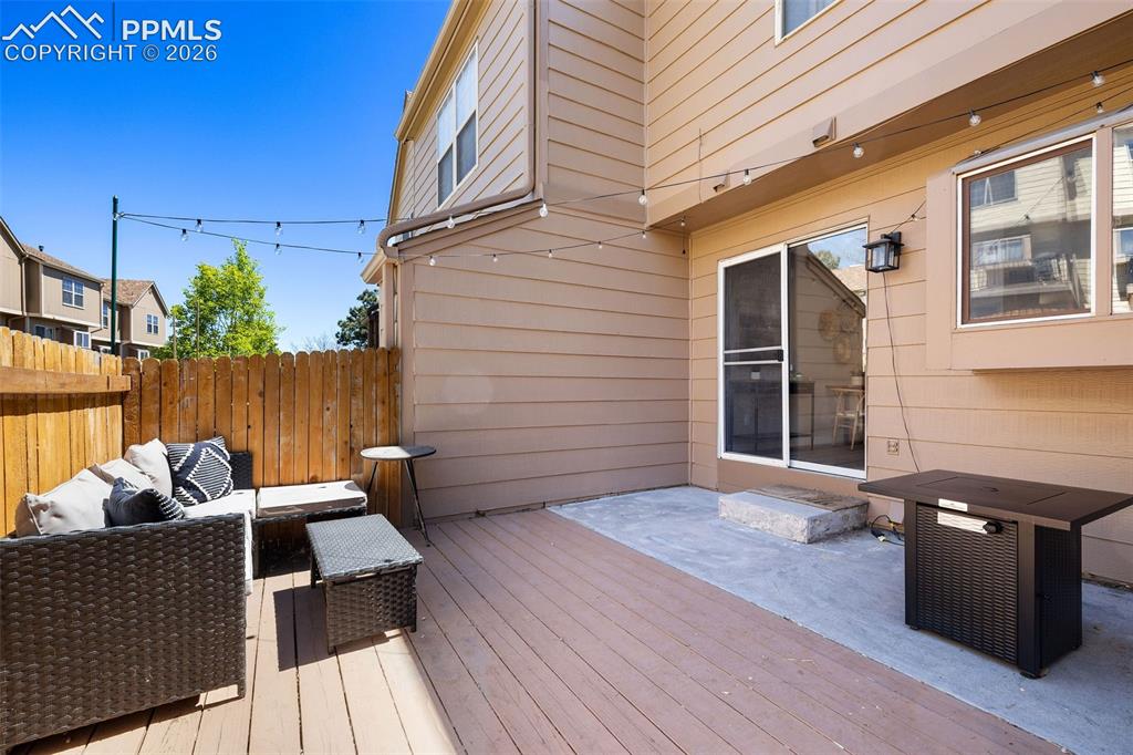 Image 26 of 26: Expansive outdoor deck and patio area featuring wood-finish decking and a c