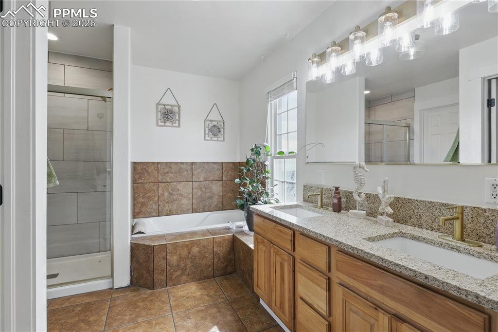 Image 14 of 43: Main-level primary suite offers a peaceful retreat with a luxurious 5-piece