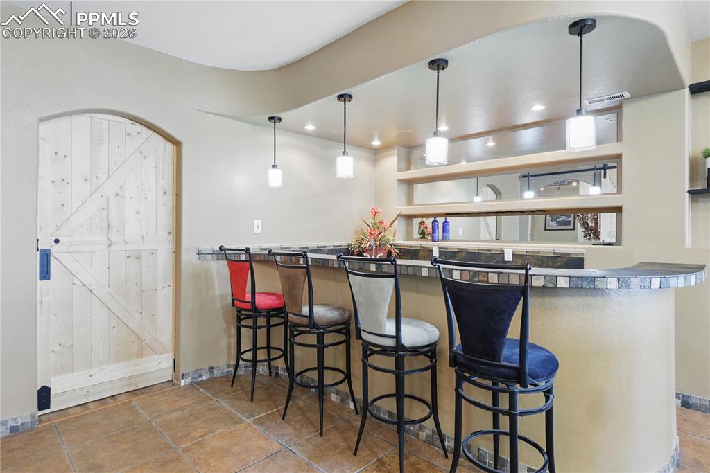 Image 23 of 43: Wet Bar and BONUS room to left of bar (not pictured- see floor plan).