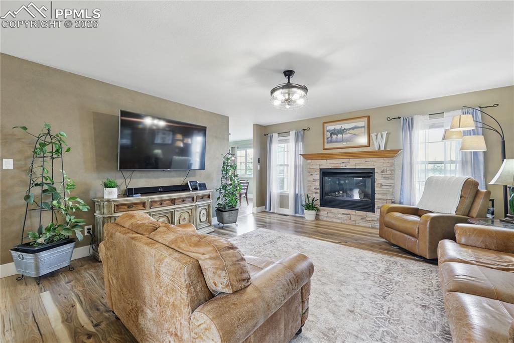 Image 5 of 43: Main level living room with cozy gas fireplace.