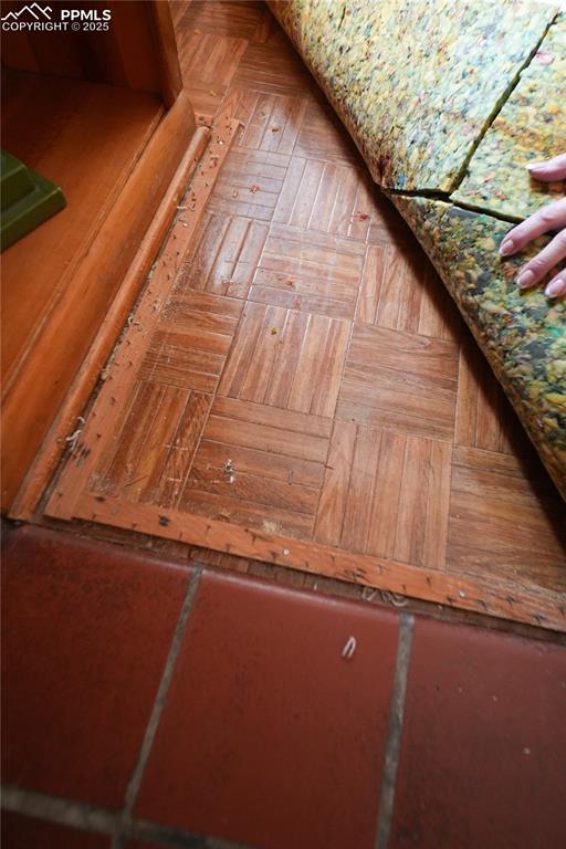 Image 21 of 28: Pull out the carpet to reveal the beautiful parquet floor in the familyl ro