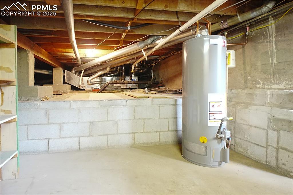 Image 23 of 28: Unfinished basement with water heater