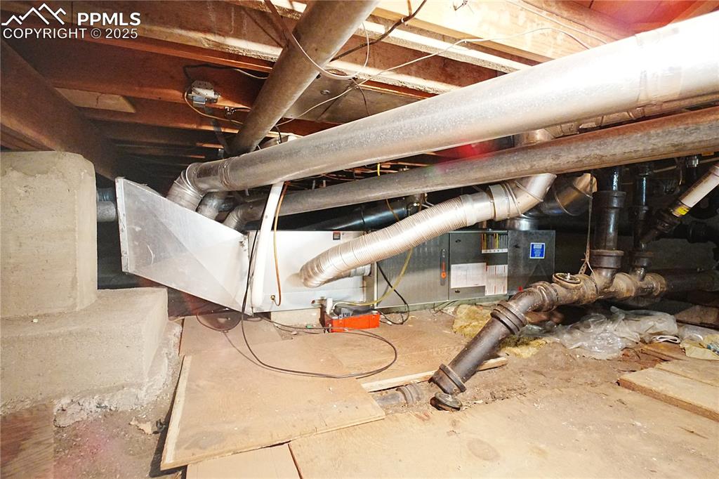 Image 24 of 28: Unfinished basement/crawl space showing furnace