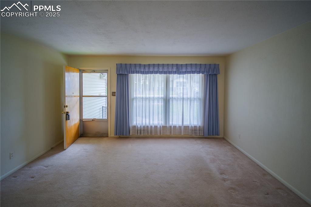 Image 5 of 28: Spacious Liv Rm with large window looking to the front of the home