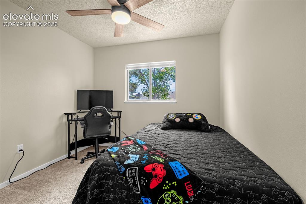 Image 16 of 29: Carpeted room featuring a ceiling fan with integrated lighting, a window wi