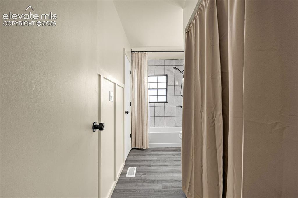 Image 18 of 29: Hallway with modern board and batten wall detailing