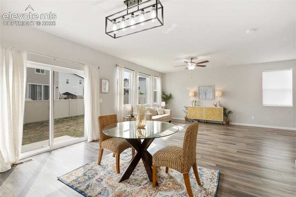 Image 11 of 27: Open-concept living space with wood-finish flooring and ample natural light