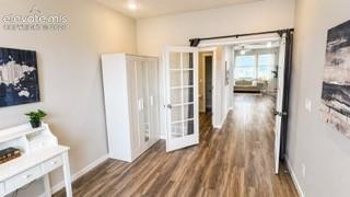 Image 13 of 27: Primary level bedroom or office space. Tall ceilings, recessed lighting, LV