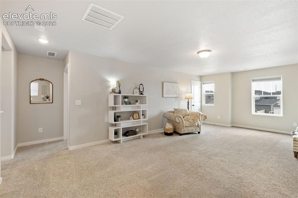 Image 14 of 27: Spacious area useful for a media space, play room & more. Large closet in t