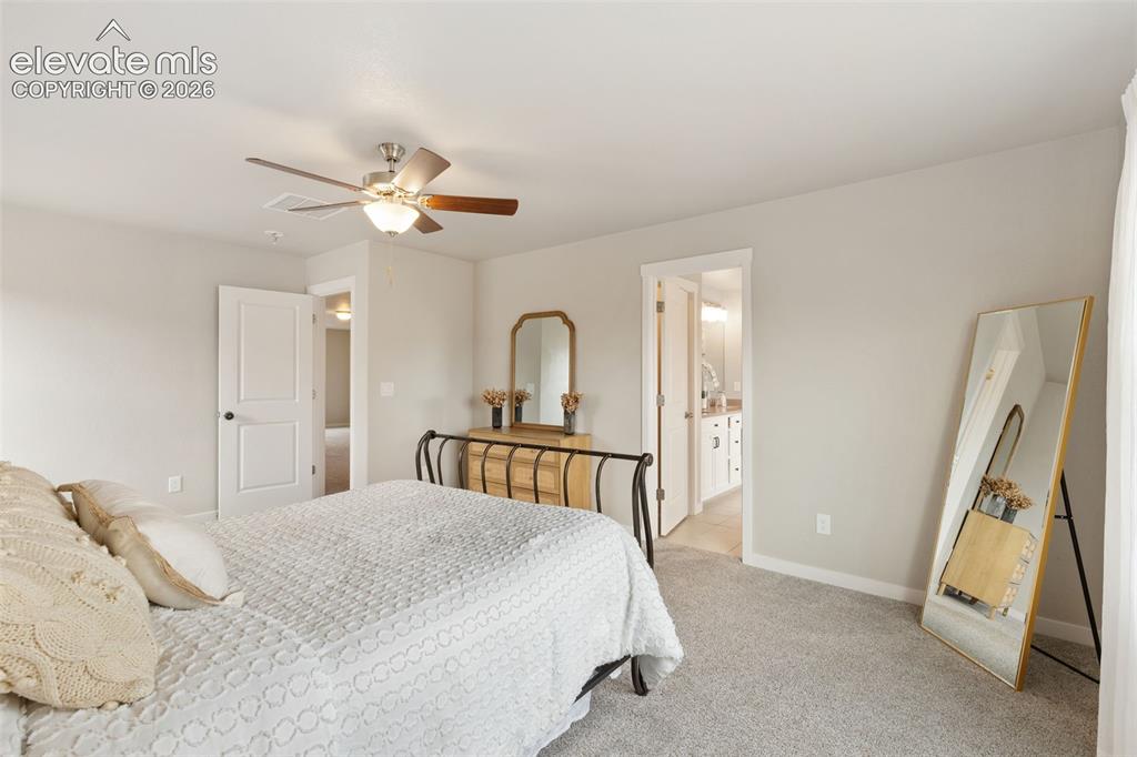 Image 18 of 27: Carpeted room featuring a ceiling fan with light fixture, light gray wall p