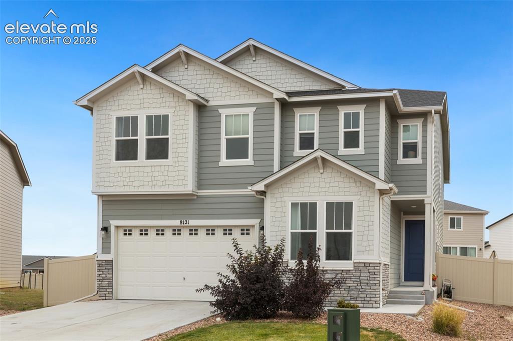 Image 2 of 27: Two-story residence featuring light gray siding and white shake accents