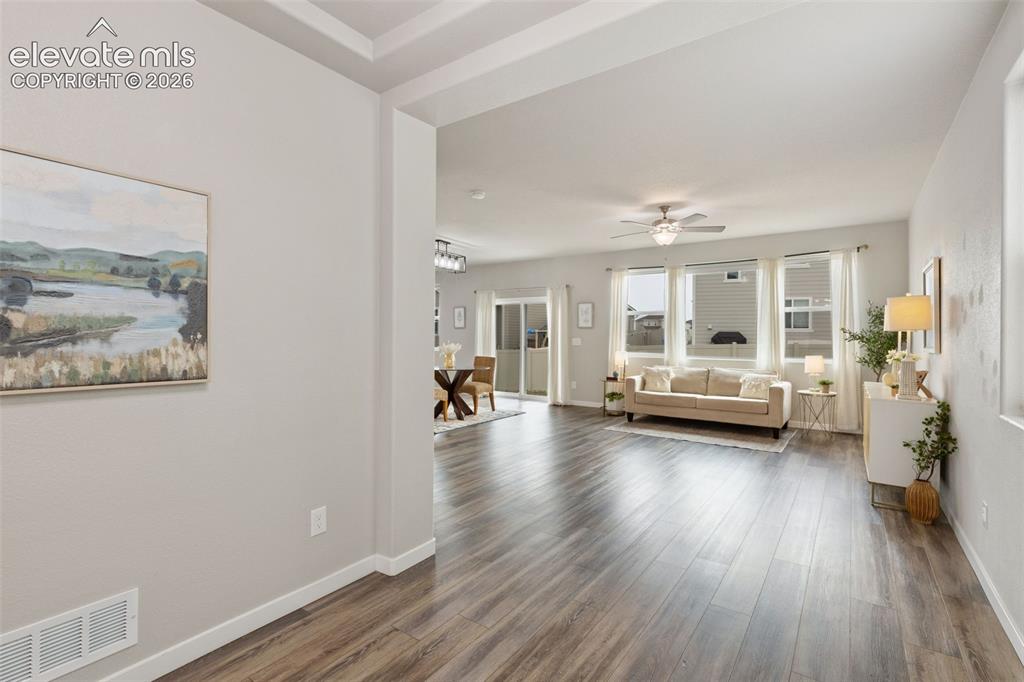 Image 3 of 27: Open-concept living area featuring wood-finish flooring, recessed ceiling d