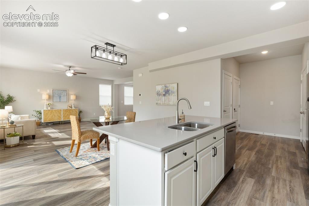 Image 9 of 27: Kitchen island featuring a dual-basin stainless steel sink with a high-arc