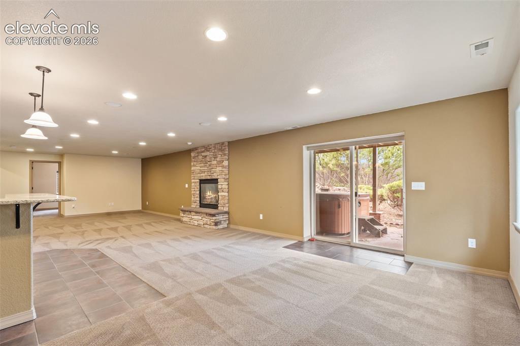 Image 35 of 43: Walk out to lower covered patio and hot tub