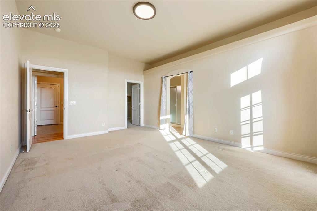 Image 14 of 32: Main level primary bedroom 