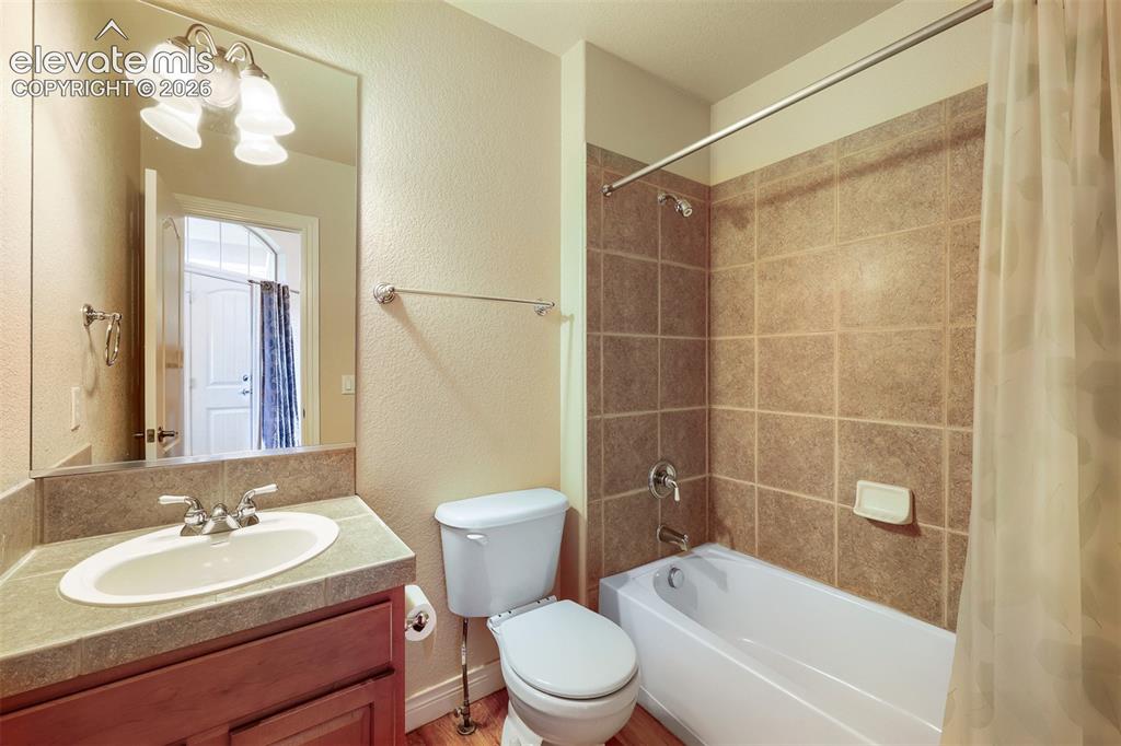 Image 18 of 32: Main level full bath located near the front bedroom/office