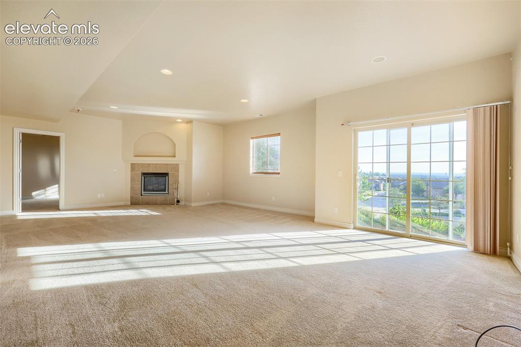 Image 20 of 32: Downstairs, the light-filled finished basement offers 9-ft ceilings, a larg