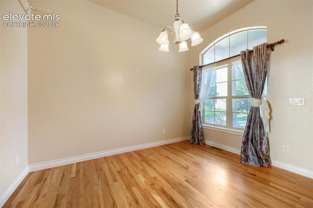 Image 4 of 32: Formal dining with plenty of natural lighting and hardwood floors