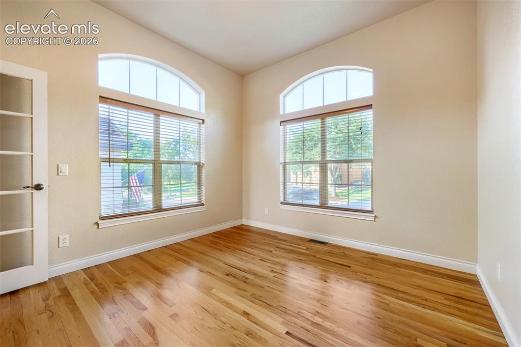 Image 8 of 32: Hardwood flooring, arched transom windows, French door, and great views!!