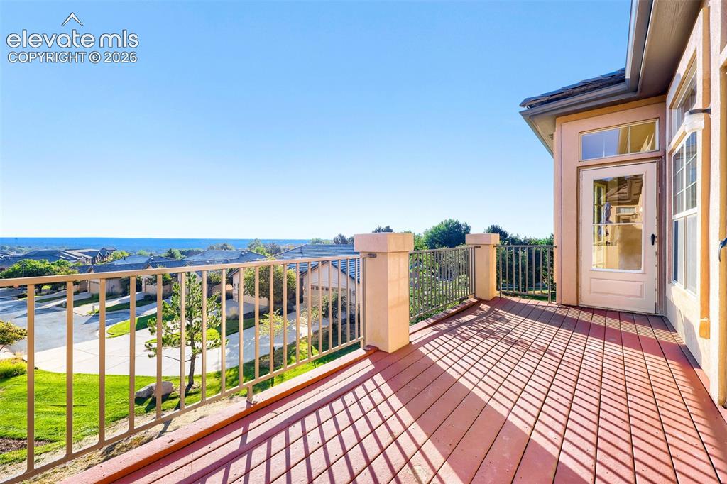 Image 9 of 32: Spacious outdoor deck with engineered wood decking, metal railing, and dire