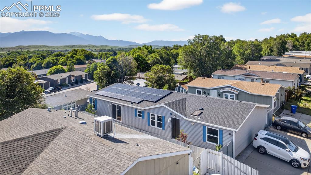 Caption: Aerial view of residential area featuring a mountainous background