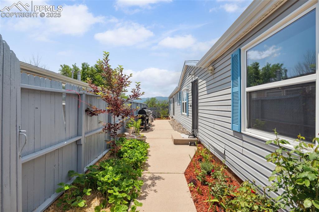 Image 10 of 34: Fenced backyard with a patio
