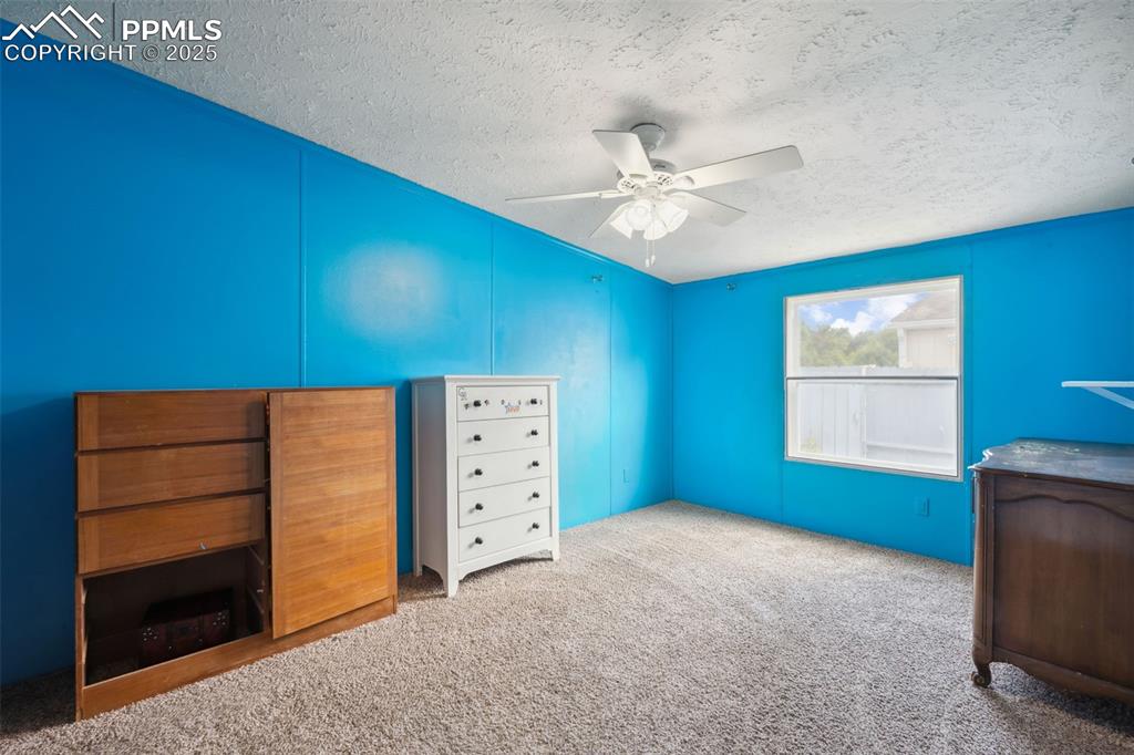 Image 30 of 34: Unfurnished bedroom featuring a textured ceiling, carpet floors, and ceilin