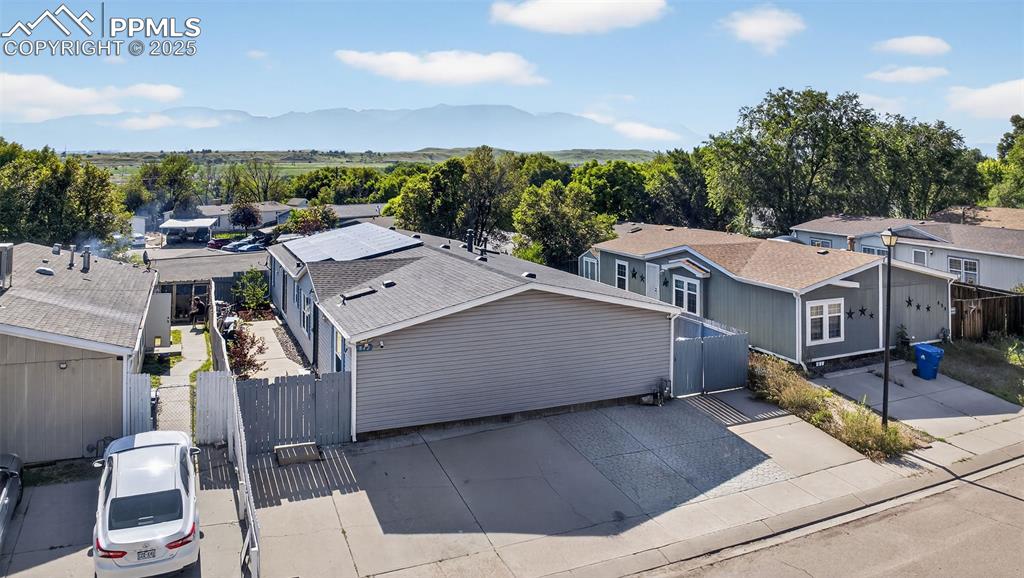 Image 4 of 34: Aerial perspective of suburban area featuring a mountainous background