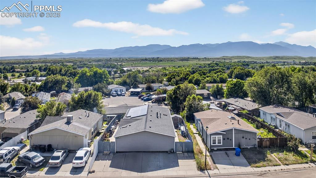 Image 5 of 34: Aerial perspective of suburban area with a mountainous background
