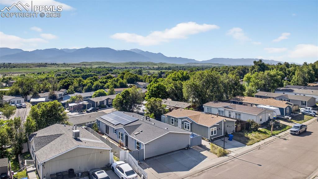 Image 6 of 34: Aerial perspective of suburban area with a mountain backdrop