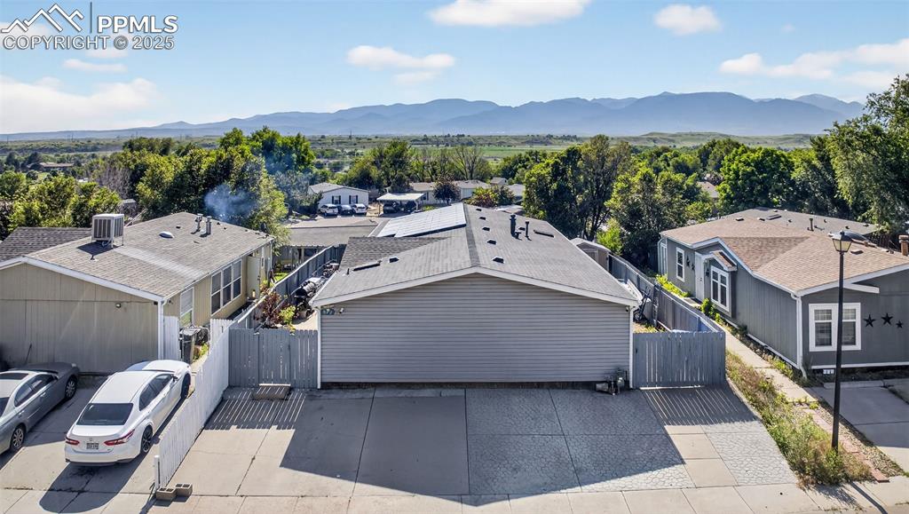 Image 9 of 34: Aerial view of residential area with a mountainous background