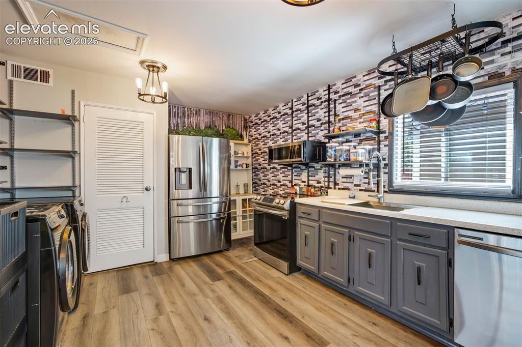 Image 10 of 29: Stainless steel refrigerator, stove, dishwasher and microwave.