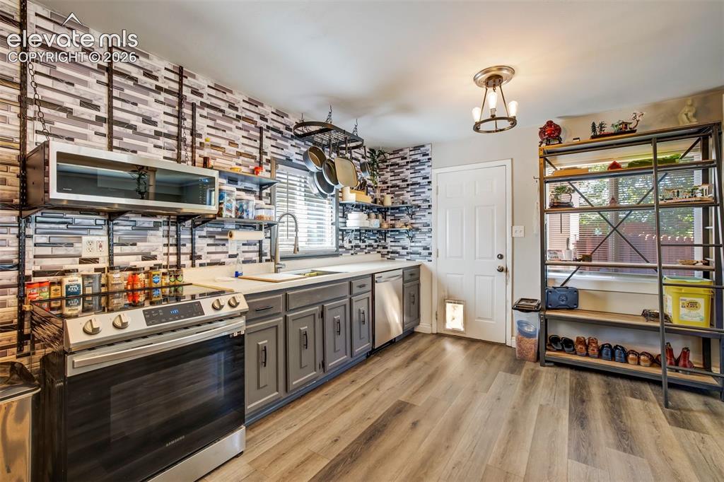 Image 11 of 29: Window above kitchen sink, hardware on lower cabinets