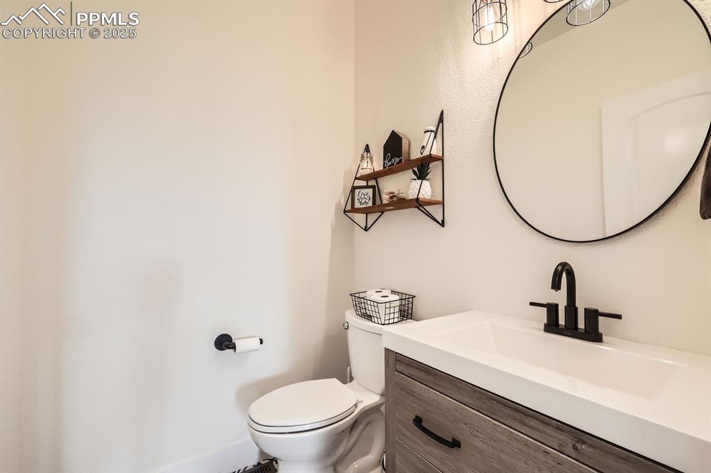 Image 12 of 29: Half bath with toilet and vanity