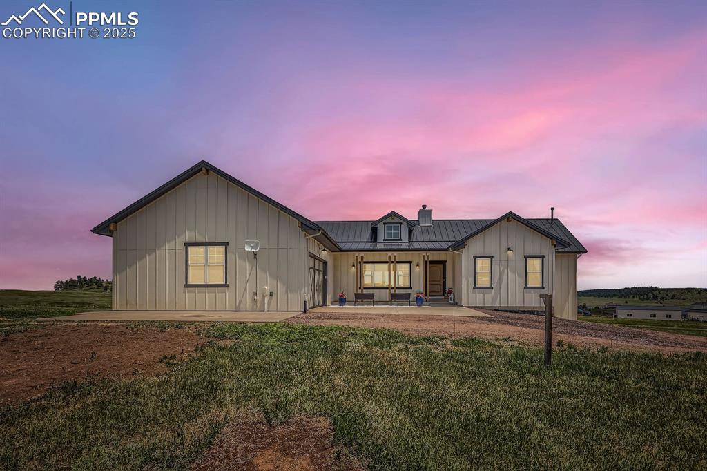 Image 2 of 29: View of front of property featuring a standing seam roof, board and batten