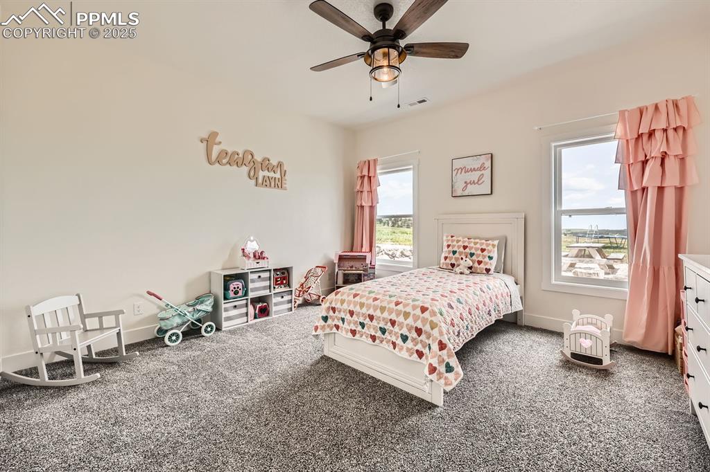 Image 22 of 29: Carpeted bedroom featuring baseboards and a ceiling fan