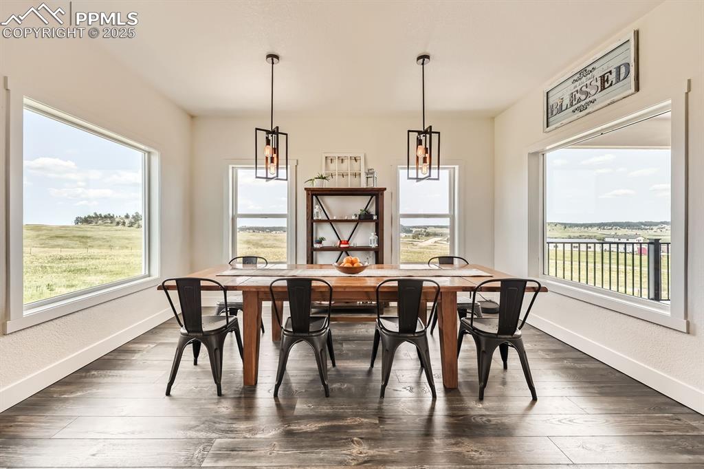 Image 7 of 29: Dining space featuring a chandelier and dark wood-style flooring