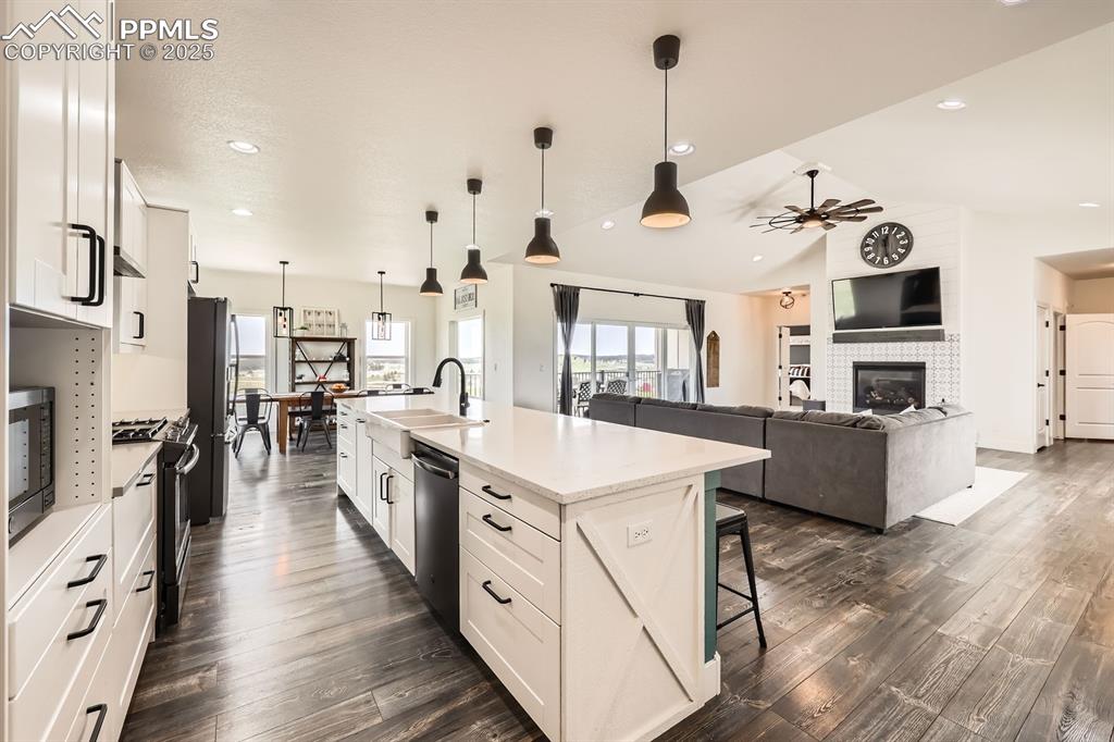 Image 8 of 29: Kitchen with ceiling fan, a kitchen breakfast bar, vaulted ceiling, recesse