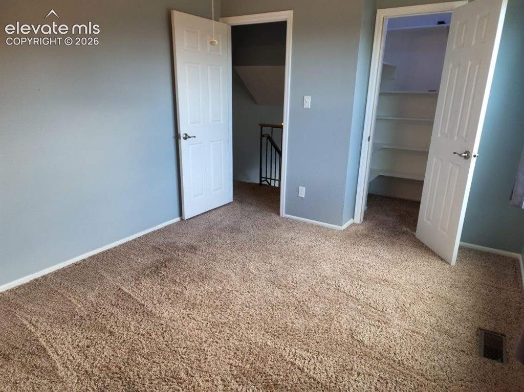Image 6 of 12: Carpeted room with a light gray wall finish, white trim, and a white panele