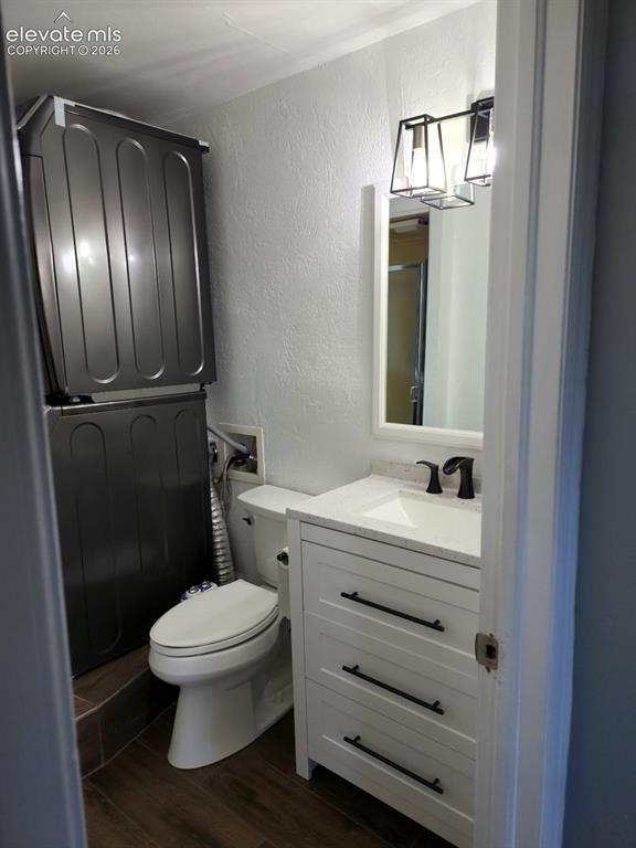 Image 8 of 12: Bathroom featuring a white vanity with integrated sink, dark hardware, and 